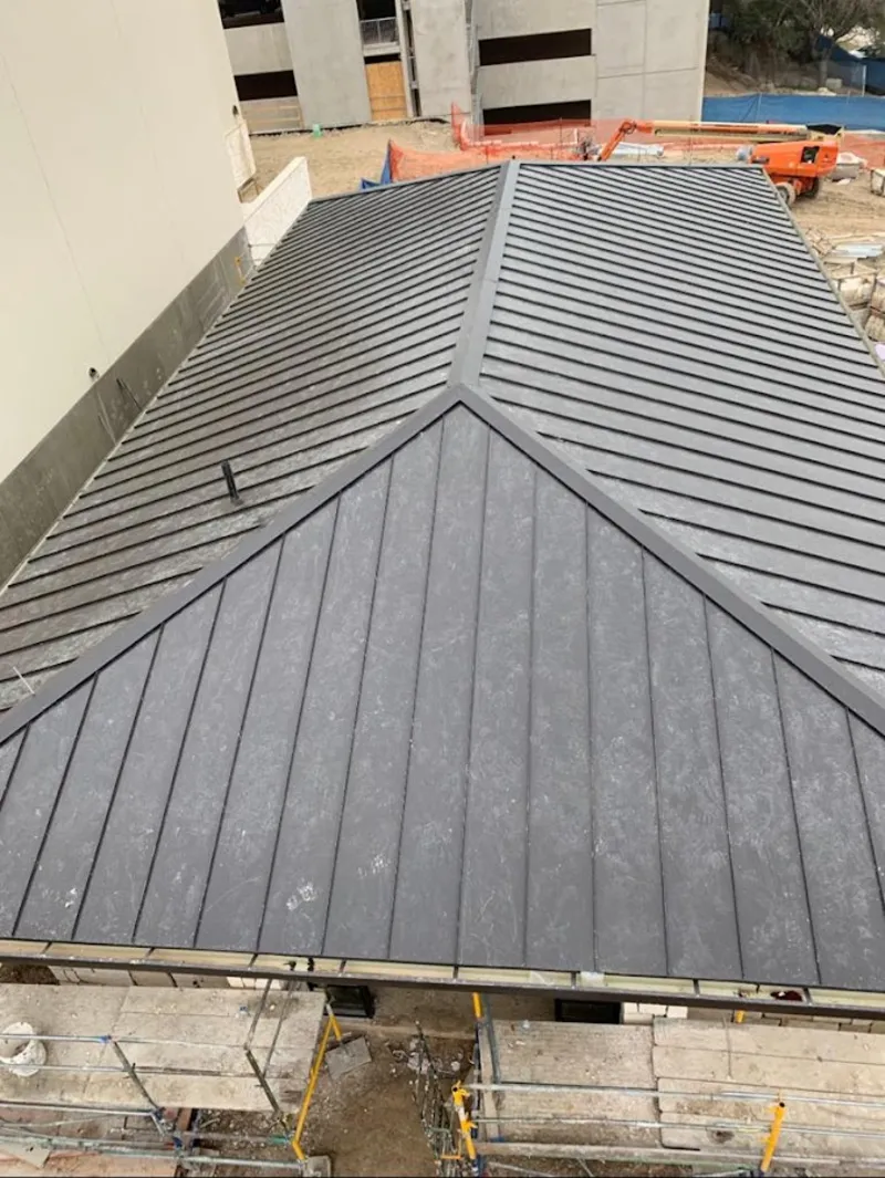 Commercial metal roof construction with crane equipment in Bullskin