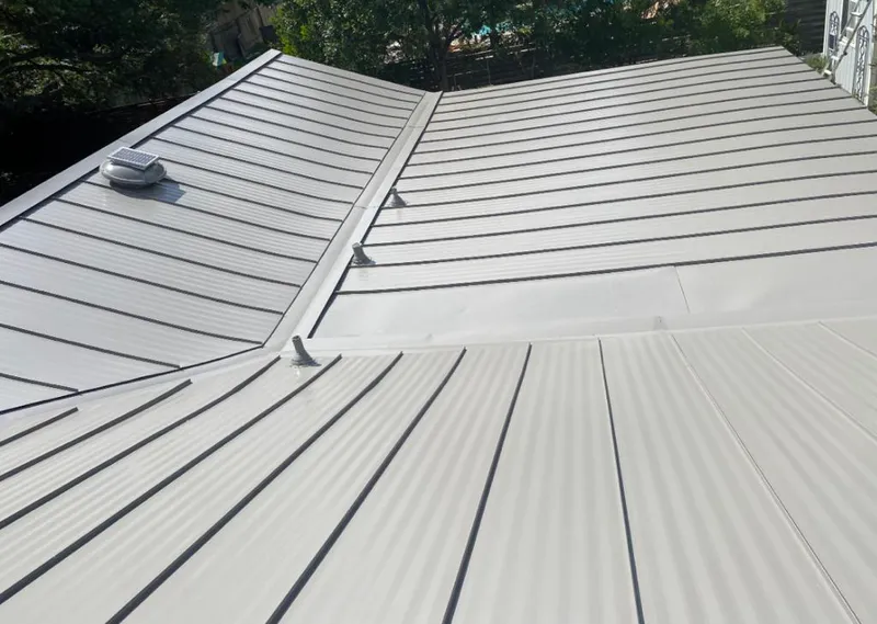 Solar attic fan installed on a metal roof for Roof Ventilation in Bullskin